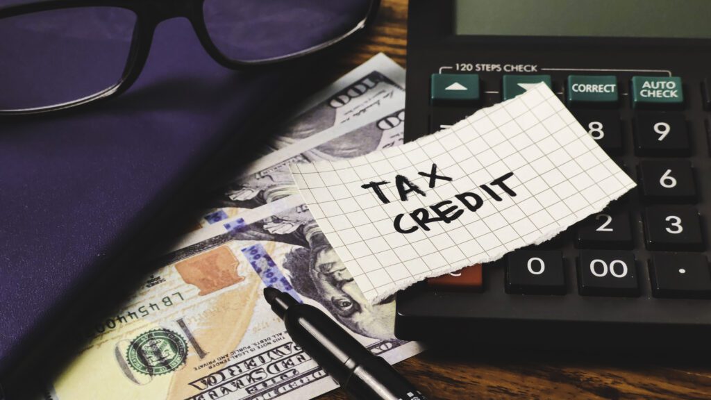 a paper that reads tax credit on top of a calculator